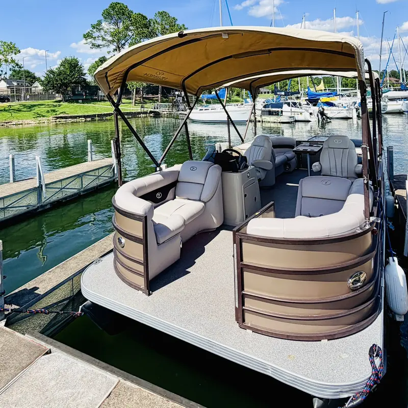 Veranda V22RC pontoon at a marina dock on Lake Conroe showing the lounge seating, helm and shaded top